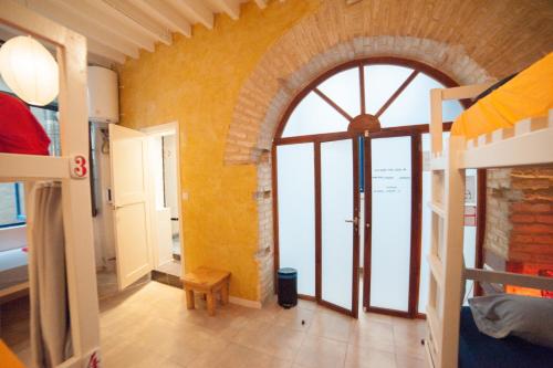 a room with a large window and a room with a bunk bed at Casa Caracol in Cádiz