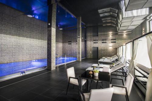 a room with a table and chairs and a pool at Château Šanov in Šanov