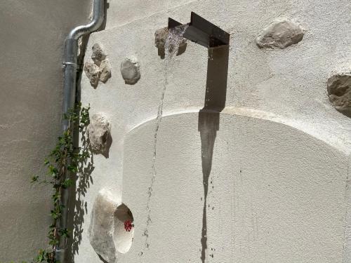 a shadow of a cross on the side of a building at Lily l'Acrobate Aubagne-Cassis-Aix en Provence in Aubagne