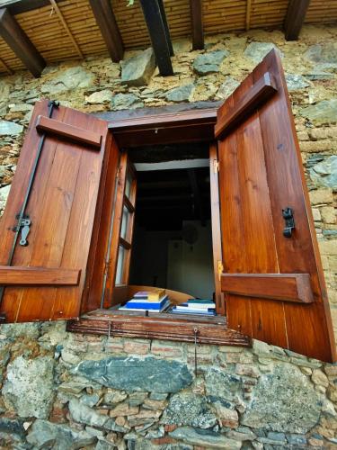 an open window in a stone building with books in it at Arhontiko Askas Mansion in Askas