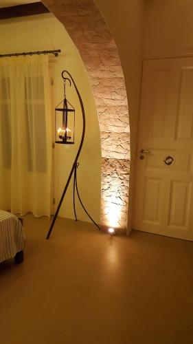 a lamp in a room next to a door at TINOS AQUA PALAZZO in Tinos Town
