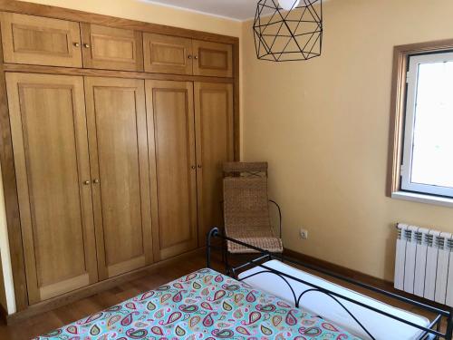 a bedroom with a bed and a window at Villa Sal - Spacious, private Apartment in a Villa with pool in Alcácer do Sal
