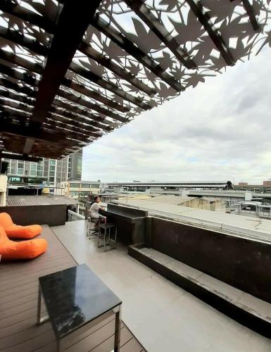 a person sitting on the roof of a building at Station8 Hostel in Bangkok