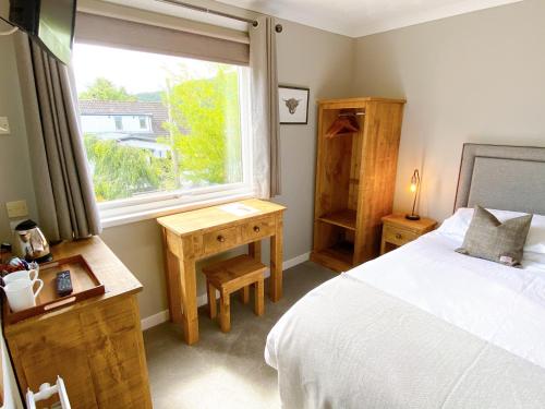 Postel nebo postele na pokoji v ubytování Cairngorm Guest House