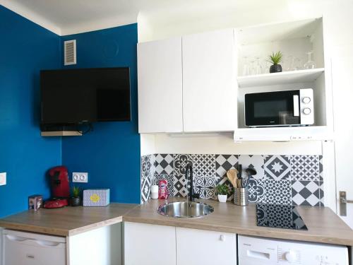 a kitchen with a sink and a microwave at LP Appart in Annecy