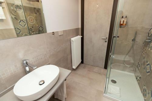 a bathroom with a sink and a shower at Er Mirin - Il Mulino di Carcare Hotel in Carcare
