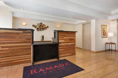 a hotel room with a rammadi sign on the wall at Ramada by Wyndham Oakland Downtown City Center in Oakland