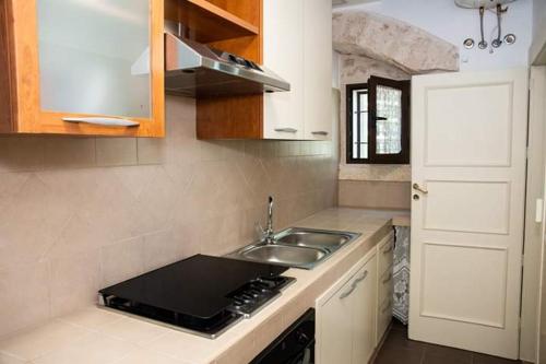 a kitchen with a sink and a counter top at Belvedere in Locorotondo