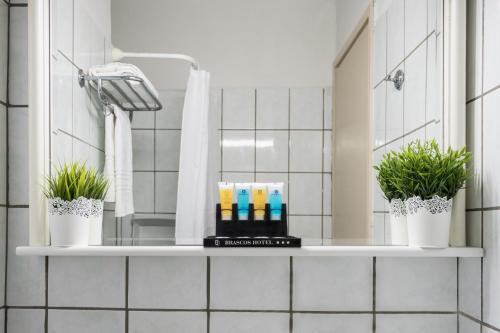 una mensola in bagno con due piante in vaso di Hotel Brascos a Rethymno