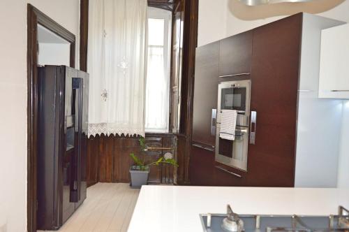 a kitchen with a refrigerator and a window at Casa Lisa in Como