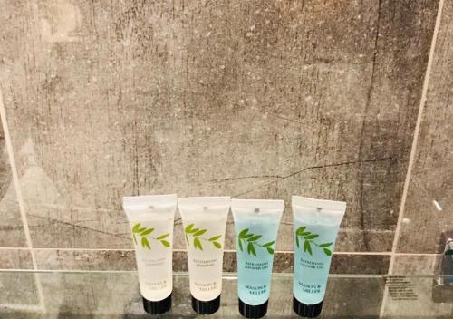 a group of four four tube of moisturizers with plants on them at The Oval House in London