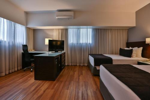 Кровать или кровати в номере Wyndham São Paulo Berrini