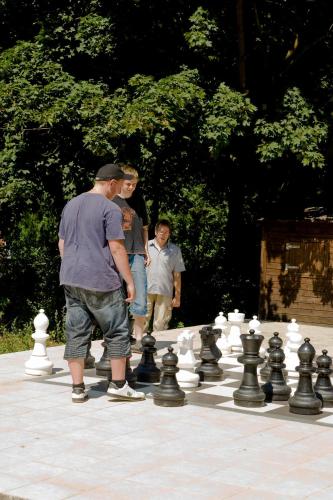 a group of people standing around a giant chessboard at Hotel Waldoase Hirschbüchenkopf in Güntersberge