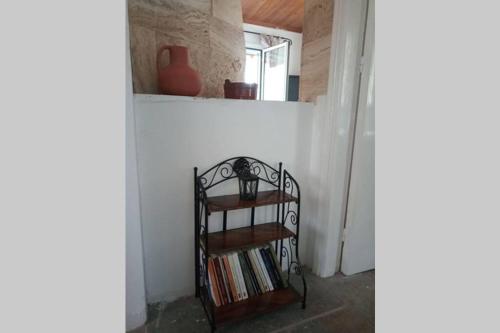 a shelf of books in a room with a window at Infinity View Villa in Koríthion