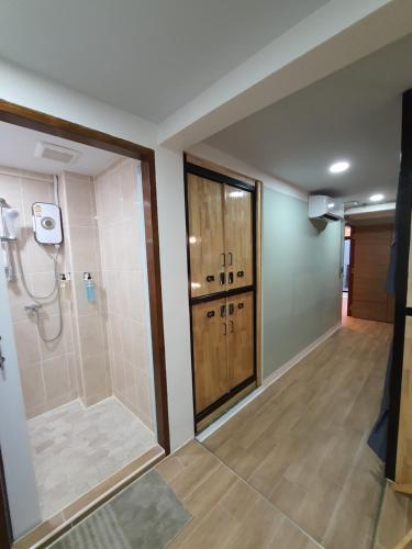 a bathroom with a shower and a shower stall at Station8 Hostel in Bangkok