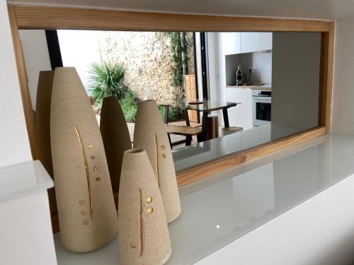 a mirror on a shelf with five differently shaped pieces at Lily l'Acrobate Aubagne-Cassis-Aix en Provence in Aubagne