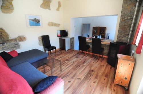 a living room with a couch and a wooden floor at Casa da fonte in Salir de Porto