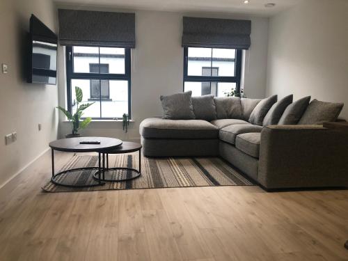 a living room with a couch and a table at Luxury apartment in the heart of Portrush Main St in Portrush