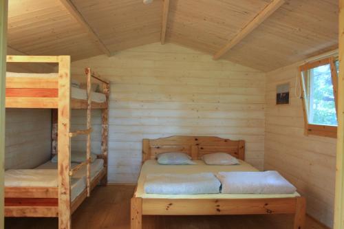 a bedroom with two bunk beds in a cabin at Pedaja Puhketalu in Nulga