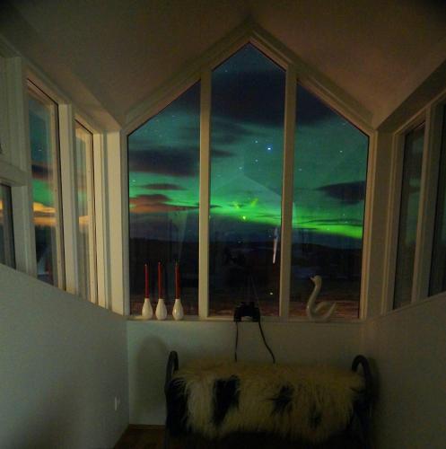 a room with a window with a view of the ocean at Hótel Lækur in Hella
