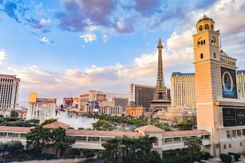 a view of a city with the eiffel tower at StripViewSuites at Jockey Club in Las Vegas