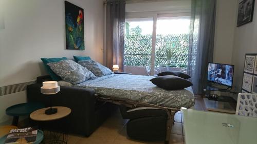 une chambre avec un lit avec des oreillers et une fenêtre dans l'établissement Nicolas 2, à Cannes