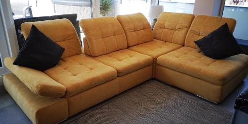 a brown leather couch with two black pillows on it at LAKE MOMENTS - Emerald Penthouse in Balatonszemes