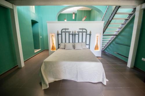 a bedroom with a bed in a room with stairs at Le Masserie Zucaro in Castel del Monte