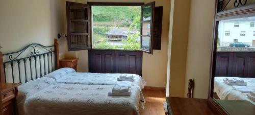 Un pat sau paturi într-o cameră la CASA MUNIELLOS
