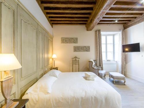 a bedroom with a large white bed and a window at Le Cara Sehiah 1D in Beaune