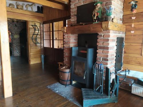 a brick fireplace with a wood stove in a room at Ubytování U Bohouše in Jilemnice