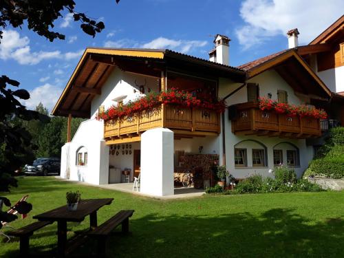 a house with flower boxes on the front of it at B&B Ai Larici in Bocenago