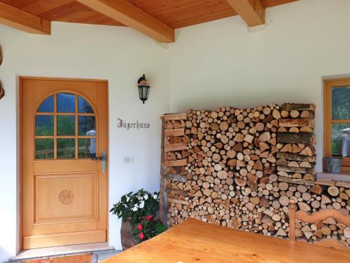 a room with a pile of fire wood next to a door at B&B Ai Larici in Bocenago