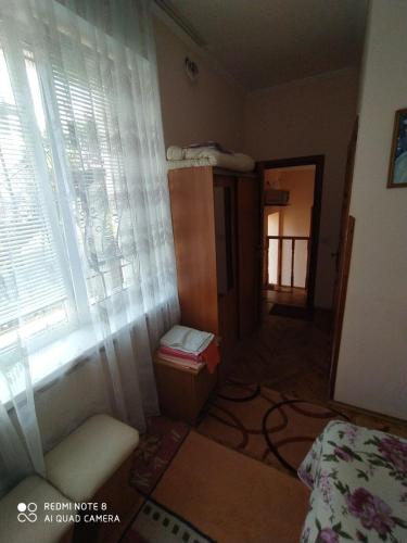 a room with a bed and a window at Sadyba Margaryta in Truskavets