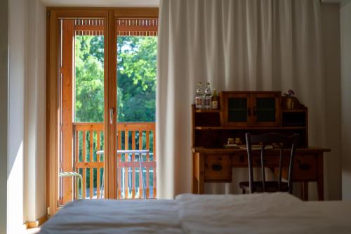 a bedroom with a bed and a sliding glass door at Zum Riesen Historic Refugium in Laces
