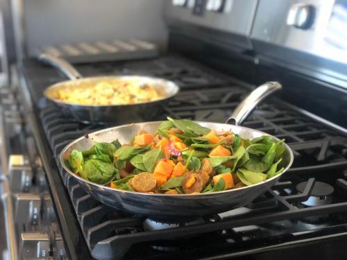 two pans of food sitting on a stove at The Victorian on Main in Fairfield