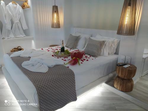 a bedroom with a white bed with flowers on it at Majestique of Naxos in Naxos Chora