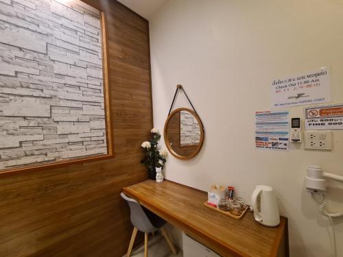 a bathroom with a wooden counter and a mirror at Samed Your House in Ko Samed