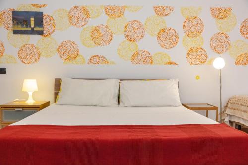 1 dormitorio con 1 cama con manta roja en Casa di Marco, en Sannicola