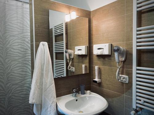 a bathroom with a sink and a mirror at Atico Hotel in Desenzano del Garda