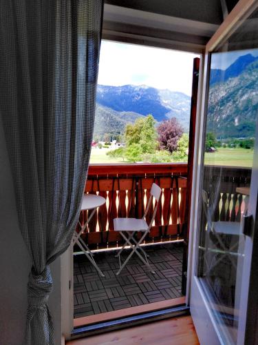 a room with a balcony with a view of the mountains at Haus Moni in Bad Goisern