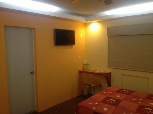 a room with a bed and a table and a chalkboard at Hotel Central in San Luis Potosí