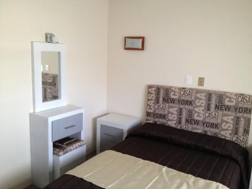 a bedroom with a bed and a mirror at Hotel Central in San Luis Potosí