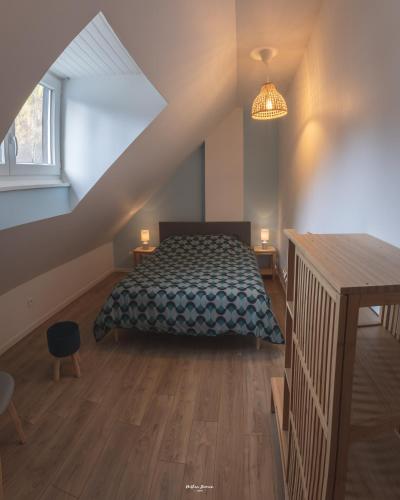a bedroom with a bed in a attic at Maison individuelle "Gite la Soulane" à 2 min de Saint lary soulan in Vielle-Aure