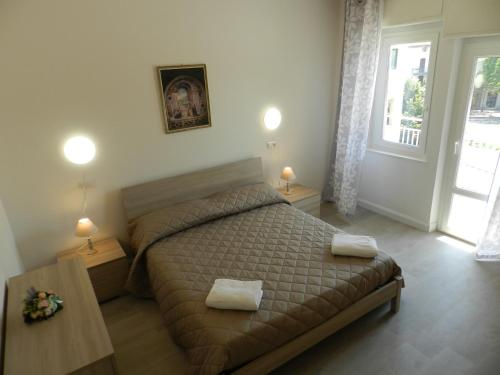 a bedroom with a bed with two towels on it at Appartamenti Via Cortonese 1 in Perugia