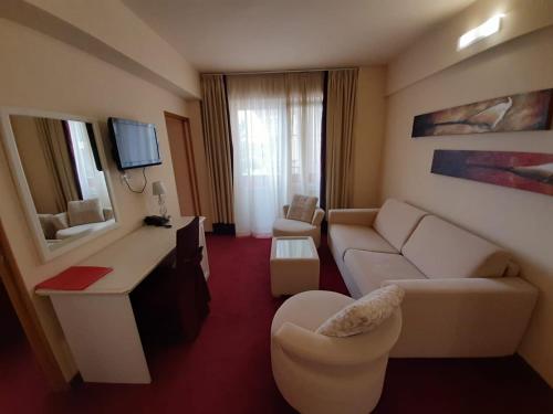 a living room with a couch and a television at Hotel Garić in Garešnica