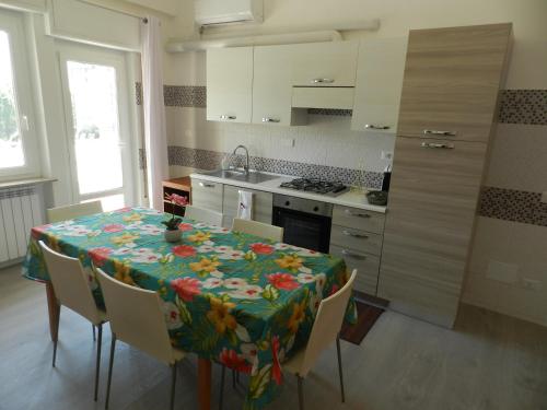 a kitchen with a table with a floral table cloth on it at Appartamenti Via Cortonese 1 in Perugia