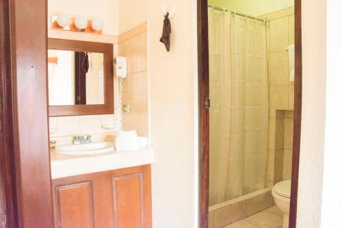 a bathroom with a sink and a shower at Hotel Pensión Bonifaz in Quetzaltenango