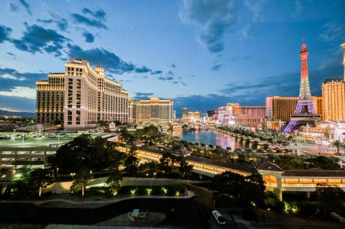a view of a city with the eiffel tower at StripViewSuites at Jockey Club in Las Vegas