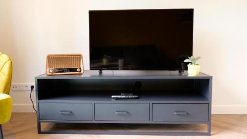 a black entertainment center with a flat screen tv on top at Sunny 45m2 Penthouse with Balcony and Terrace - R65C in Eindhoven